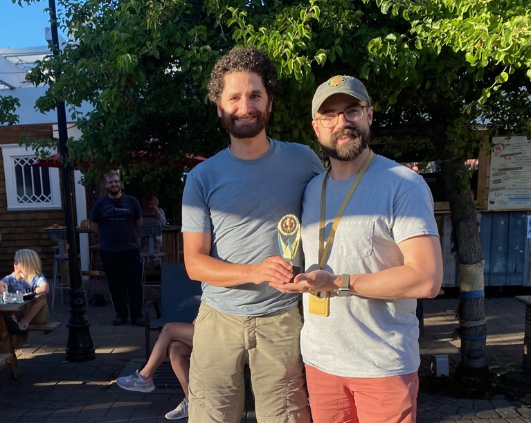 A2025 Chess Champion Blake S (left) receives his trophy from 2024 Champion Daniel B.