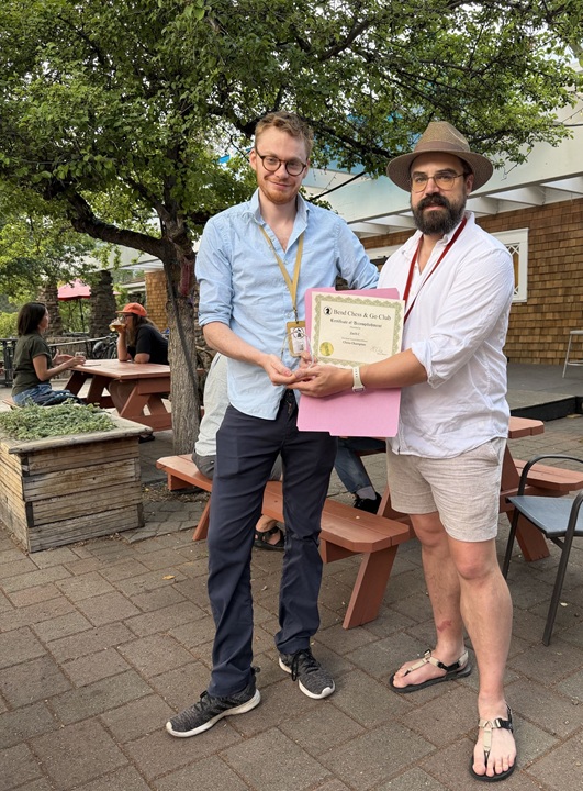 2026 Chess Champion Zach C receives his trophy from Dean C